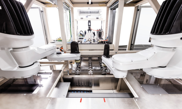 Synchronized robot station for automated manufacturing processes